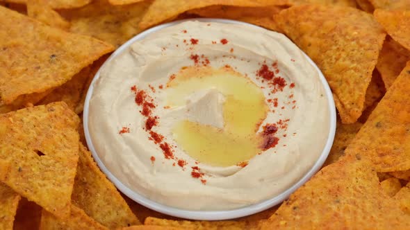 Snack hummus with smoked paprika and tortilla chips rotate