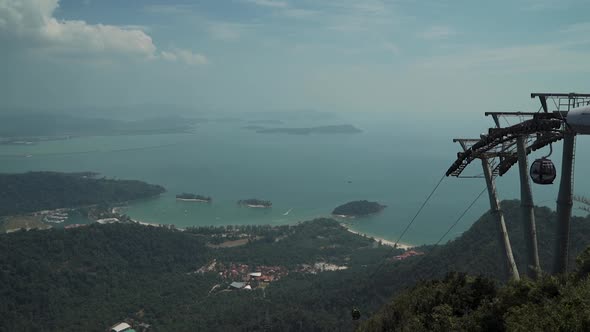 Mountain top view of Langkawi islands in the Andaman sea with a cable car on the right