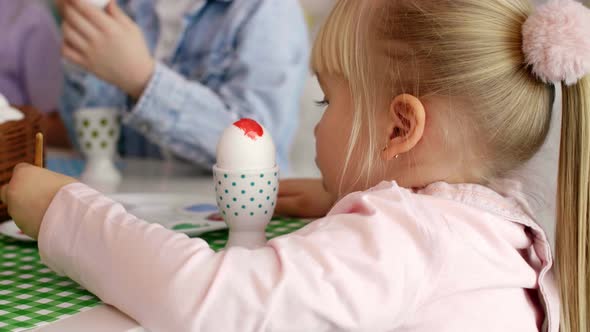 Close up Of Girl Painting Easter Egg 