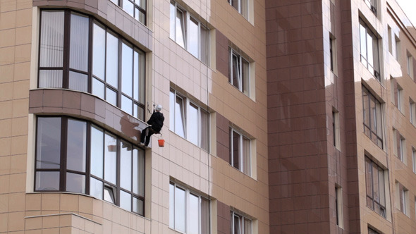Man Washes The Windows Of Office Building 1