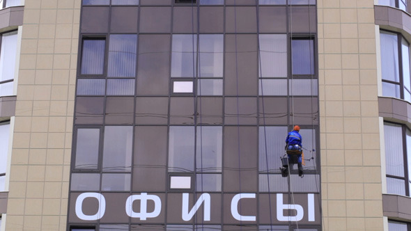 Man Washes The Windows Of Office Building 2
