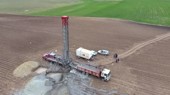 Drilling Rig Work on Flat Agricultural Brown Field