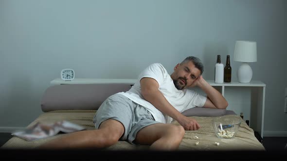 Man Falling Asleep While Eating Popcorn in Front TV, Bachelor Passive Lifestyle