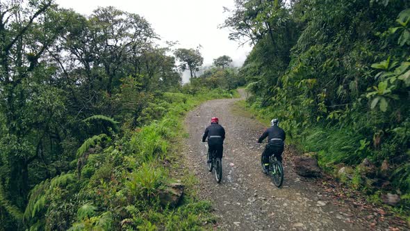 Drone Following Two Bikers Riding on the Death Road in Mounain of Bolivia