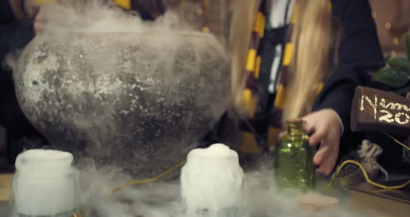 Wizard School Students are Brewing a Potion in a Big Pot Steam