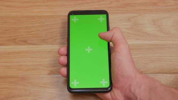 Man Scrolls Smartphone Green Screen