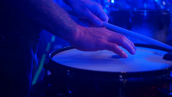 Truck right of male hands making sound check of drum. Testing sound quality.