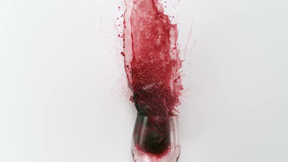 Red wine splashing out of glass, Slow Motion