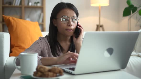 Woman Talk on Phone and Look Through Laptop Spbd