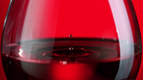 Super Slow Motion Shot of Wine Drop Falling Into Red Wine in Glass at 1000Fps.