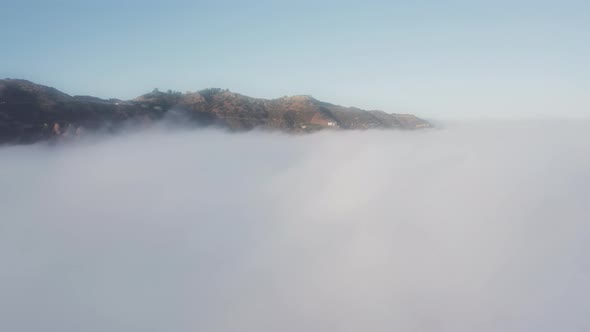 Aerial of Heaven Over Cinematic Clouds at Sunrise Flying Over White Clouds