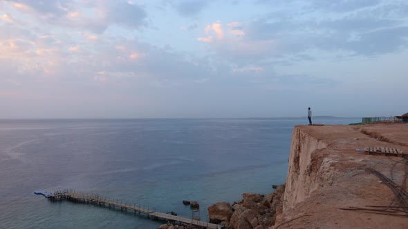 Aerial View to Calm Blue Sea Sandy Beach with Rocky Coastline