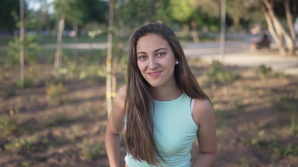 a Cute White Girl in a Medium Shot Looking and Smiling at a Camera