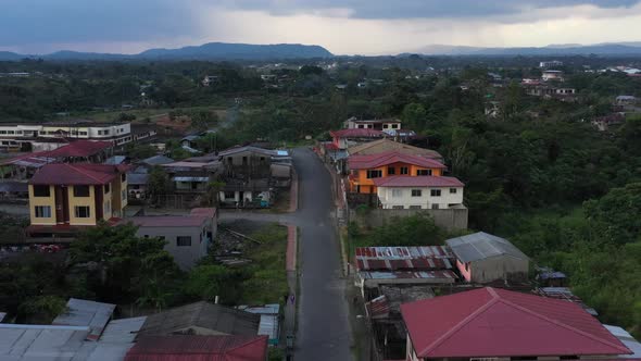 Flying over a street and showing the various types of houses in a small south american town