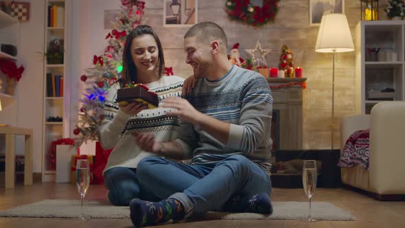 Young Woman Surprising Her Husband with a Gift