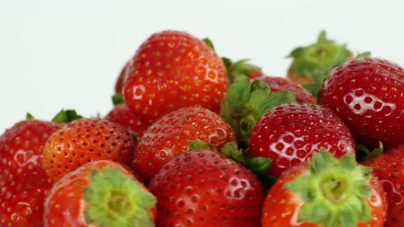 Juicy ripe exotic strawberry rotates on a white background 360. Eco fruits and berries summer.