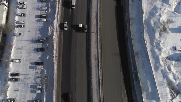 Top down aerial shot of winter road with lots of cars in city 13