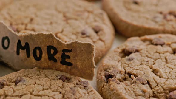 Round Chip Cake Cookies with Chocolate on Flat Surface with Paper Label No More Slow Rotating Loop