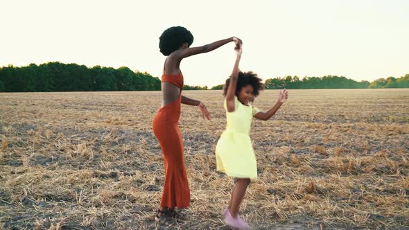 Mom and daughter spending time in a field