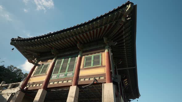 Bongeunsa Temple - Clouds time lapse over Ancient Korean traditional Pagoda Building with tiled roof