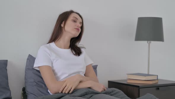 Woman Thinking While Sitting in Bed