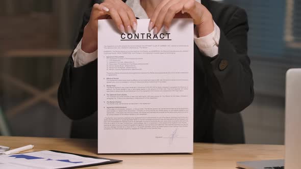 Businesswoman Holds Contract in Her Hands and Ripping It Apart