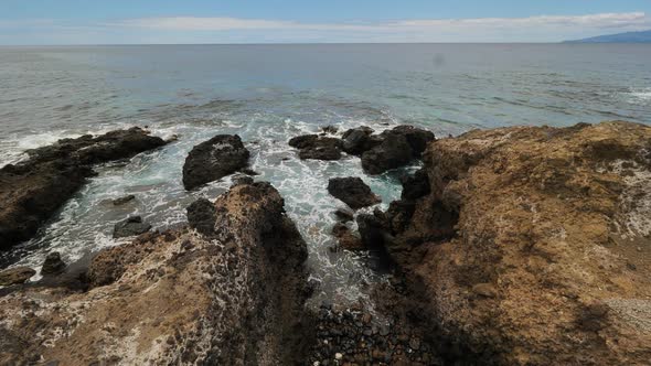 Static shot of the sea waves hitting the rocks