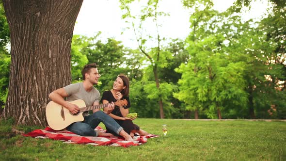 Young Beautiful Couple Smiling Resting in Park