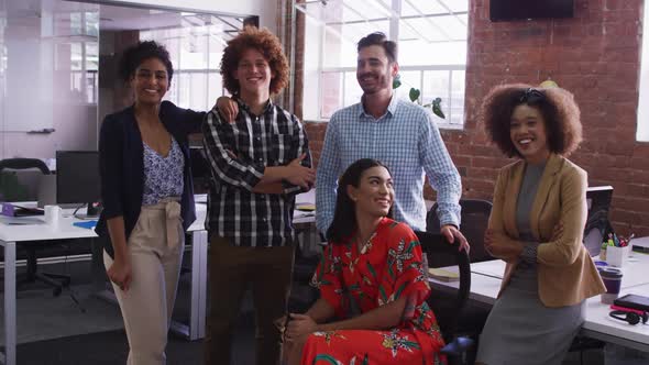 Group of diverse business colleagues smiling at camera in office room