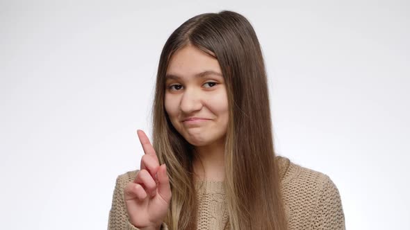 Portrait of Smiling Teenage Girl Shaking Her Head and Showing No Gesture with Index Finger