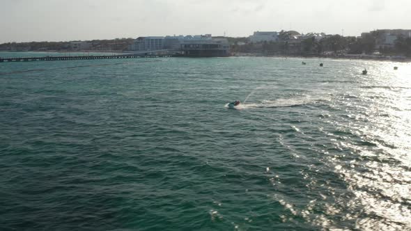 Riding the Waves with Jet Ski While Cruising on the Caribbean Sea at Playe Del Carmen Mexico