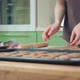 Young Woman in Brown Tshirt Baking Cookies on a Silicon Mat at Home Kitchen - VideoHive Item for Sale