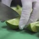 Person Cuts Fresh Ripe Juicy Lime Into Slices on Green Board - VideoHive Item for Sale