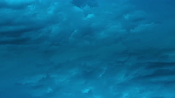 Timelapse of movement of dark blue night heavy clouds 4k footage alt