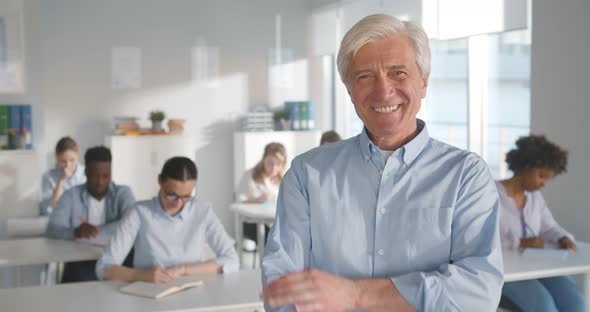 Portrait of Mature Teacher Looking at Camera in Classroom