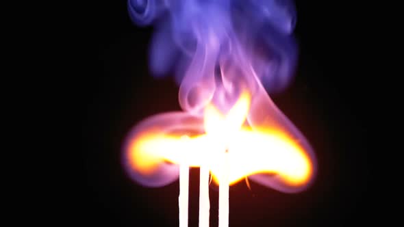 Three Matches Are Lit a Flame on a Black Background and Then Goes Out Creating a Lot of Smoke