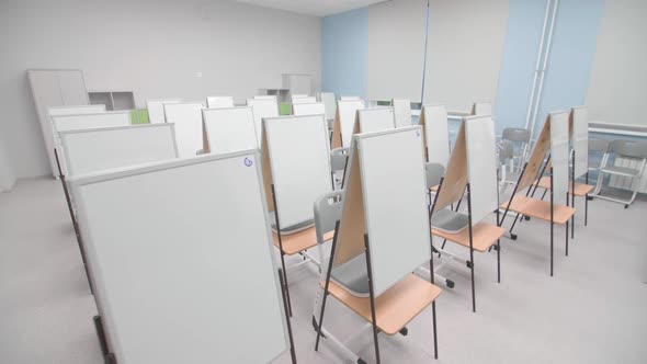 Whiteboard Folding Easels and Chairs in Empty Classroom