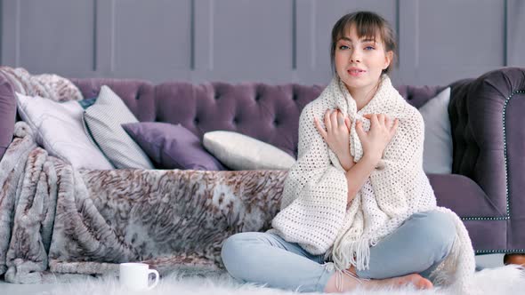 Full Shot Cute Young Woman Trying Getting Warm Wrapped in White Fluffy Plaid Sitting on Carpet