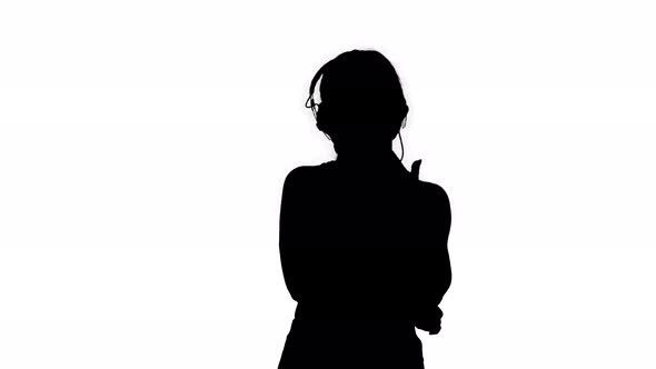 Silhouette Young Sporty Beautiful Woman Enjoying the Music in Headphones