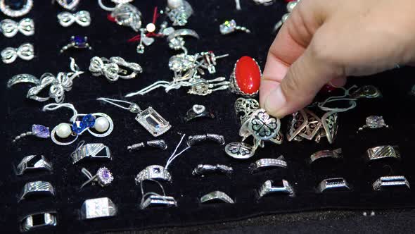 Female Fingers Choosing Jewelry.