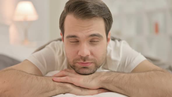 Close Up Serious Man Looking at Camera in Bed