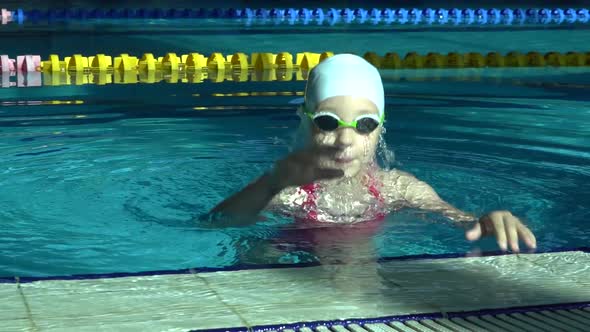 Handsome Young Girl Emerges From Under Water in the Swimming Pool