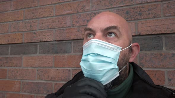 Male security guard adjusting protective corona virus medical PPE mask
