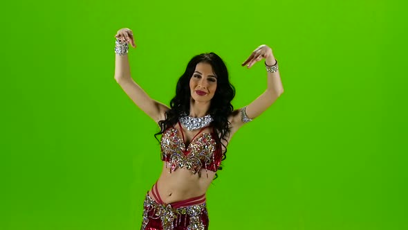 Attractive Girl Performing a Belly Dance . Green Screen. Slow Motion