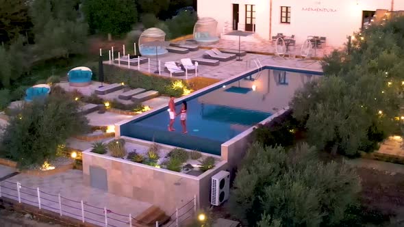 Couple on Vacation at Luxury Resort in Sicily During Sunset By the Infinity Pool in Sicilia Italy