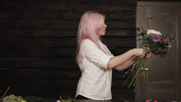 Young Woman Determines the Design of a Bouquet and Composition Holding a Set of Flowers