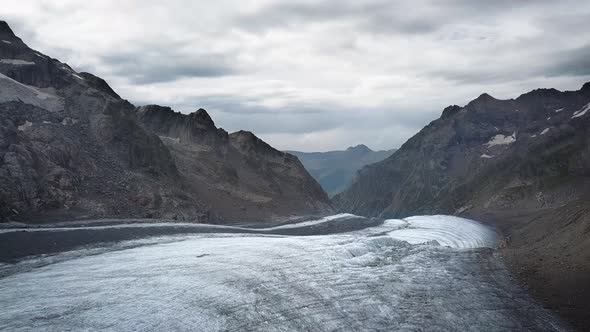 travelling above a glacier in the swiss alps range in Europe with the Grindelwald valley in the back