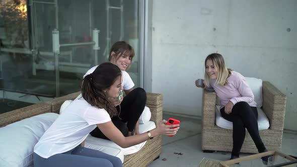 Company of women relaxing together on terrace