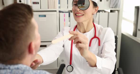Otorhinolaryngologist Performs Physical Examination of Patient Throat  Movie