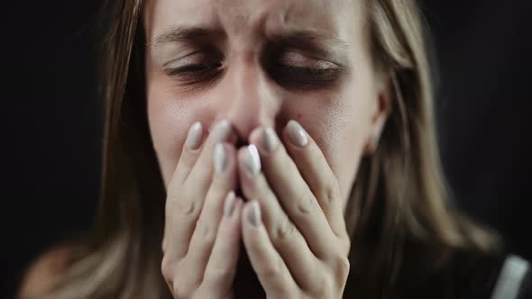 A Sad Beaten Up Woman with Tear in Eye and Bruises is Crying